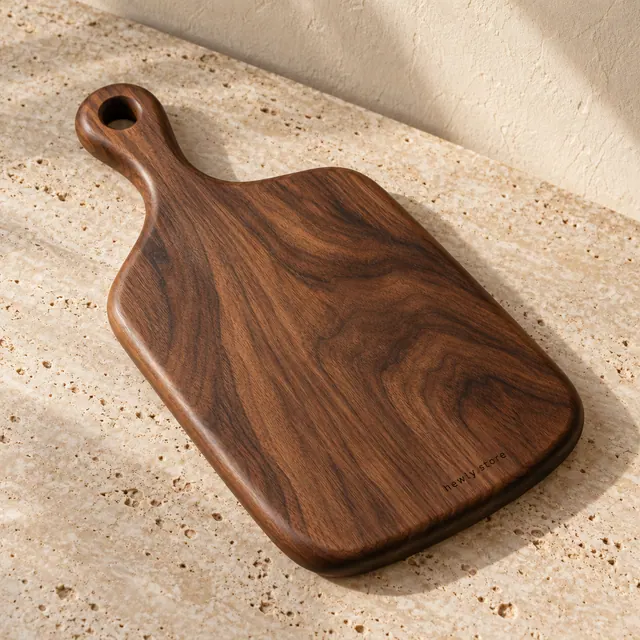 Small walnut decorative paddle-board concept on pale stone